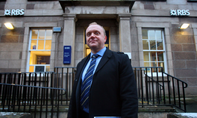 Detective Sergeant Murray Coull outside the Kirriemuir branch of RBS.