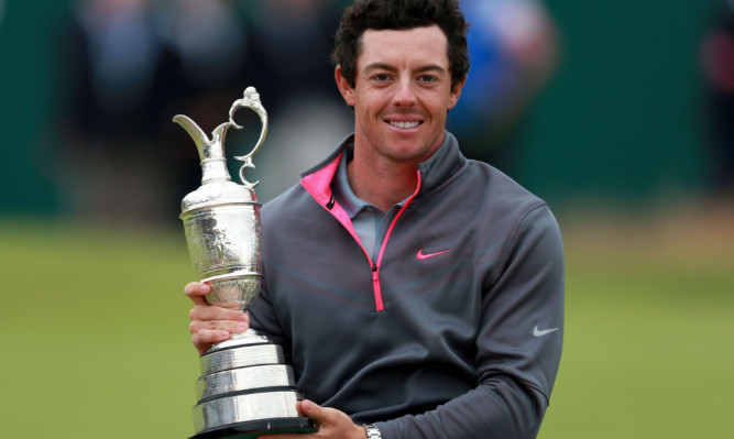 Rory McIlroy celebrates with the Claret Jug after winning the 2014 Open Championship.