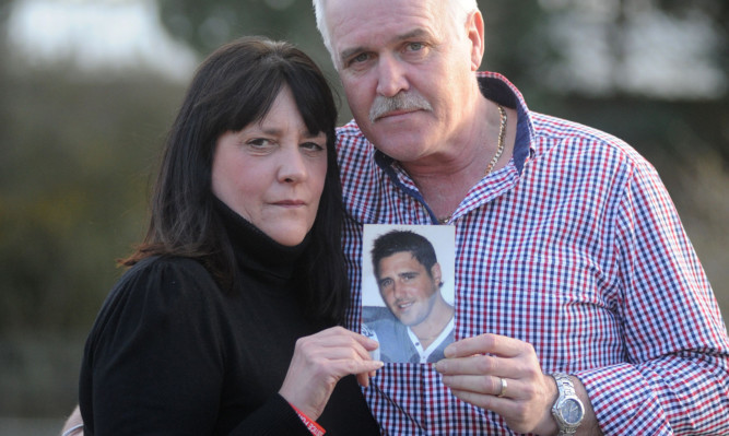 Anti-knife campaigner Alan McLean with wife Tina and a photo of Barry.