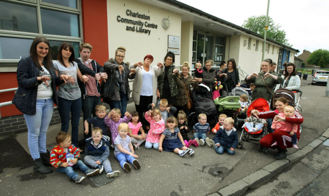 Mums and kids giving the 'thumbs down' to the management group at the Charleston Community Centre after the closure of the Mucky Pups playgroup.