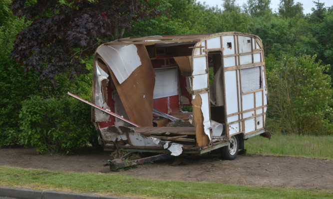 Travellers left rubbish and a caravan at the side of Whitworth Road.