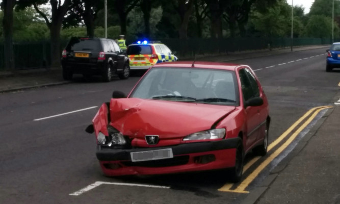 The red Peugeot was badly damaged in the collision.