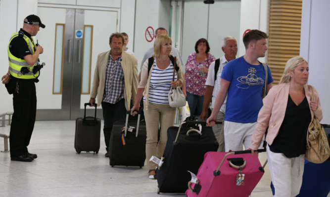 Passengers arriving back at Glasgow Airport.