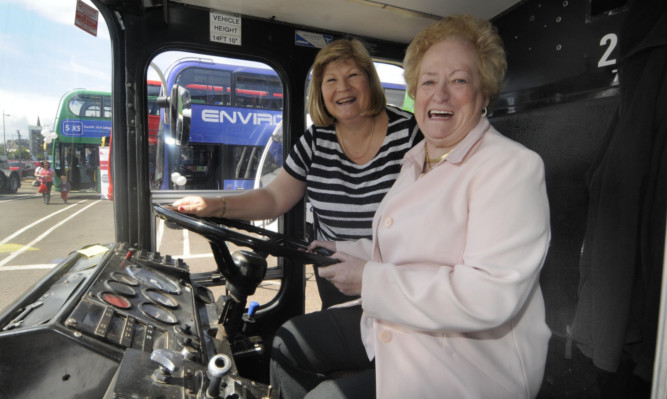 Dundees first female bus driver, Elizabeth Anne Marnock, back behind the wheel of a Volvo Ailsa, with Elsie Turbyne, of National Express Dundee.