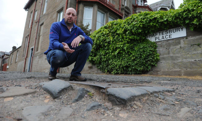 Scott Craig beside some of the uneven surfaces left by HGVs.