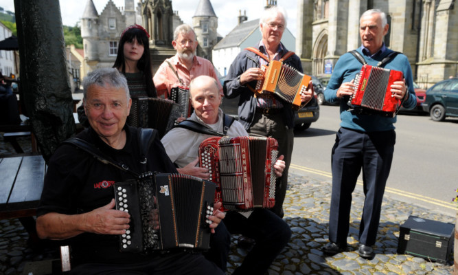 At Fergie MacDonalds button key accordion workshop are, front: Fergie and Alex Houston; back, from left: Catherine Steight, David Corner, Pete Shepheard and Gus Campbell.