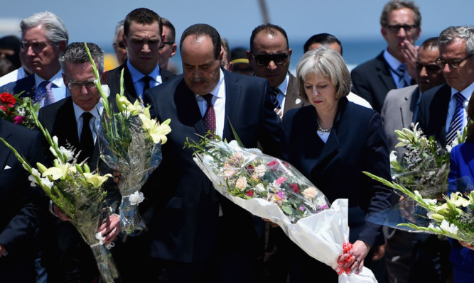 Home Secretary Theresa May lays flowers at the scene of the beach attack.