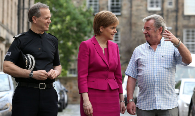 First Minister Nicola Sturgeon with Police Scotland Chief Constable Sir Stephen House (left) and Michael Brown, whose daughter Clare was murdered by her ex-boyfriend in 2009.