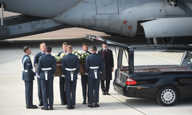 The coffin of  one of the victims of last Friday's terrorist attack, is taken from the RAF C-17 aircraft at RAF Brize Norton.