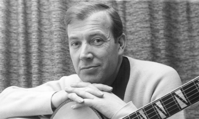 Val Doonican with his guitar in 1965.