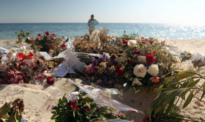 Flowers remain on the beach near the RIU Imperial Marhaba hotel in Sousse, Tunisia, after last weeks terror attacks.