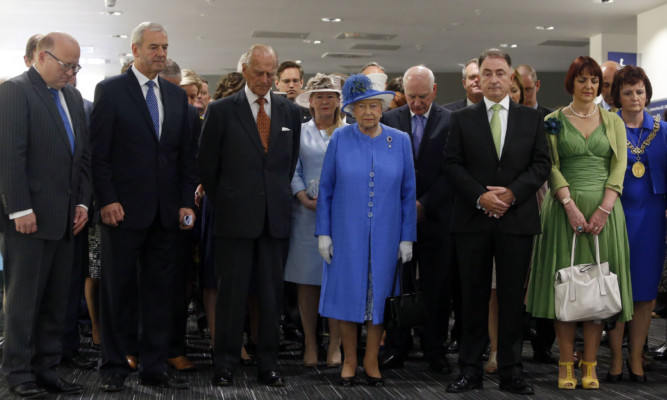The Queen and the Duke of Edinburgh observing the silence during a visit to Strathclyde University.