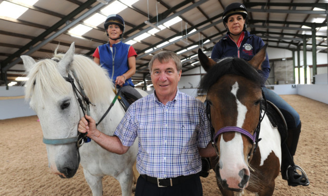 Geoff Brown with Riding for the Disableds Gemma Paterson on Blue, left, and Angie Welch on Jigsaw at the new centre at Kinfauns.