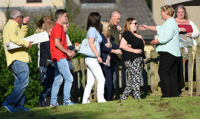 The family of Billy and Lisa Graham arrive for the vigil.