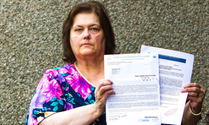 Maureen Mills, from Invergowrie, with the fraudulent letters she received in the post claiming that she had won the Euromillions Baku Lottery.