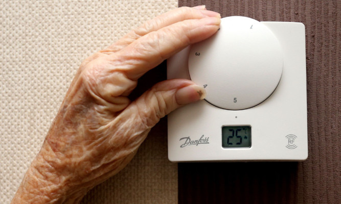 Jane Burney 94, from Childwall alters the thermostat in her home. The start of winter effects pensioners with concerns over heating bills PRESS ASSOCIATION Photo. Issue date: Wednesday November 19, 2014. See PA story . Photo credit should read: Peter Byrne/PA Wire