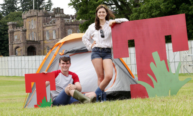 The youngest members of the Roberts family Liam (19) and Jess (17), pitch the first tent in the T in the Park 2015 campsite.