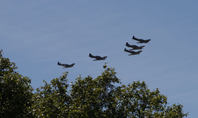 The RAF flypast, containing three Spitfires and two Hurricaines, to mark the 75th anniversary of the Battle of Britain, passes over  Buckingham Palace in London.