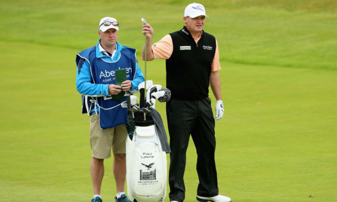 Paul Lawrie and caddie Davie Kenny contemplate his second shot to the first hole at Gullane yesterday.