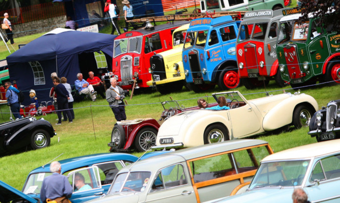Kris Miller, Courier, 11/07/15. Picture today at Glamis for the Glamis Scottish Transport Extravaganza where thousands of vintage vehicles are expected over the weekend with displays and shows on for visitors. Pic shows visitors viewing the vehicles.