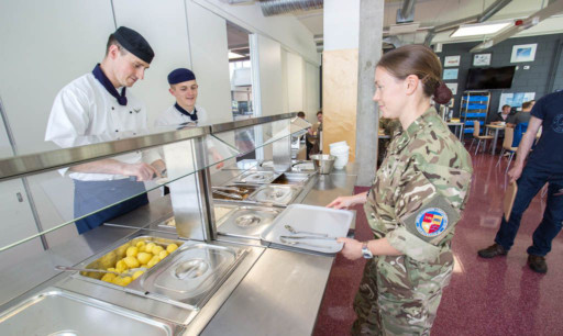 Scott serves up tasty British food to another satisfied customer.