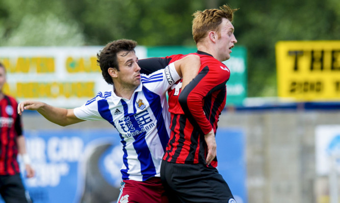 Liam Craig holds off his opponent during the match with Real Sociedad.