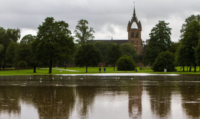 Picture of flood water at the South Inch with St Leonards-in-the-Fields Church in the background.