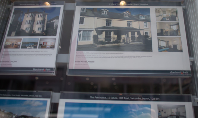 SALCOMBE, ENGLAND - JUNE 01:  Properties for sale are displayed in an estate agent's window in the seaside town of Salcombe on June 1, 2015 in Devon, England. In a recent study by the Halifax the South Devon resort is now the most expensive seaside town, overtaking Sandbanks in Dorset, with average house prices in the second-home hotspot now reaching £672,874, with prices in the town seeing a massive 69 percent rise over the past decade.  (Photo by Matt Cardy/Getty Images)