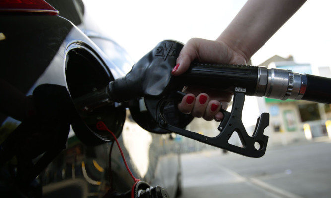 A car being filled up with a pump at a petrol station in London. PRESS ASSOCIATION Photo. Picture date: Sunday August 3, 2014. Photo credit should read: Yui Mok/PA Wire