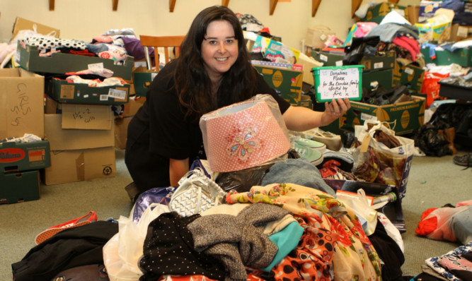 Togs For Tots founder Jordan Butler with some of the donations for the family.