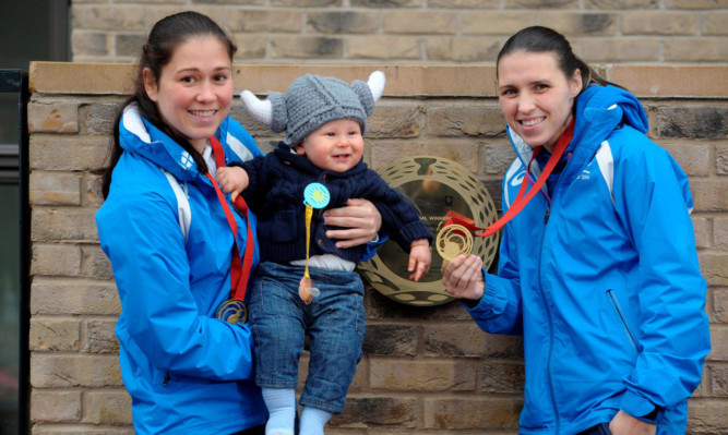 Commonwealth Games judo champions sisters Louise (left) and Kimberley Renicks, along with the youngest resident Jude Reid unveil a plaque outside their Team Scotland house.