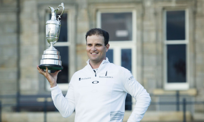 Zach Johnson celebrates with the Claret Jug after winning The Open Championship at St Andrews.