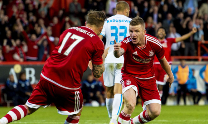 Jonny Hayes, right, with David Goodwillie after bringing the Dons level.