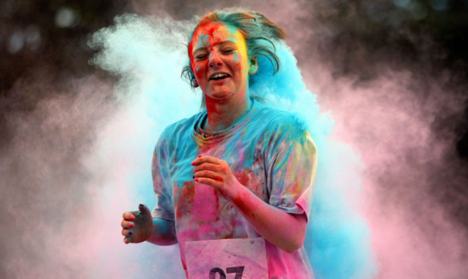 The runners are covered in coloured powder during the race.