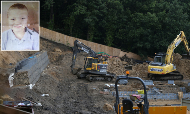 The body of 7-year-old Conley Thompson (inset) was found on a construction site on Bank End Road in Barnsley.