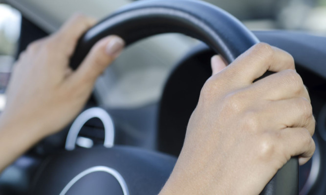 Woman holding a steering wheel