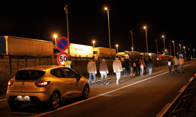 About 2,100 migrants tried to storm the area surrounding the Eurotunnel on Tuesday before being repelled by police.