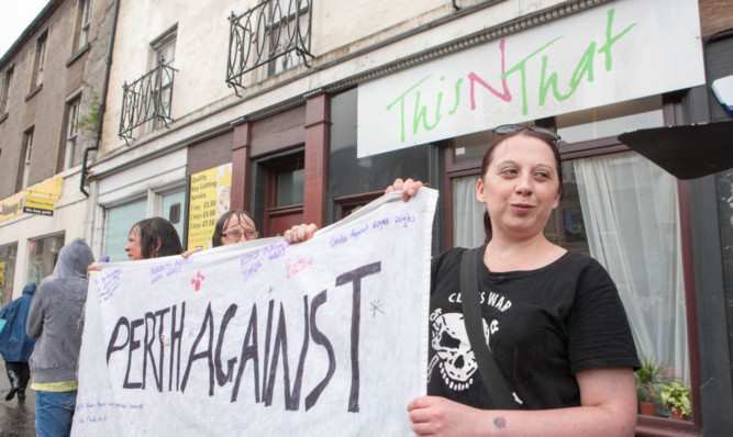 Katie Della Bennett and fellow protesters outside the This N That shop in Perth.