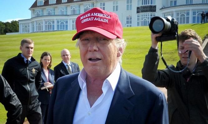 Donald Trump speaks to the media after arriving by helicopter at his Trump Turnberry golf course in Ayrshire.