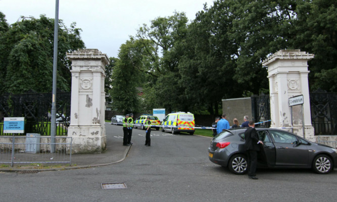 Police on the scene at Greenock Cemetery after a man was found covered in blood.
