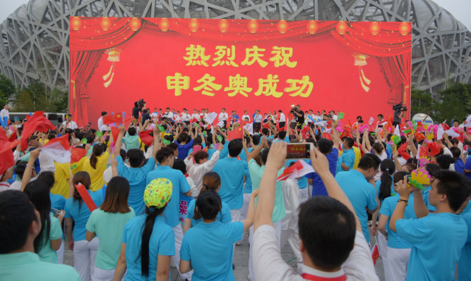 People celebrate at Olympic Plaza as Beijing wins the bidding of 2022 Olympic Winter Games.