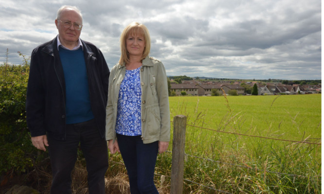 Residents Tony Spence and Susan Coull at the site of the proposed houses.