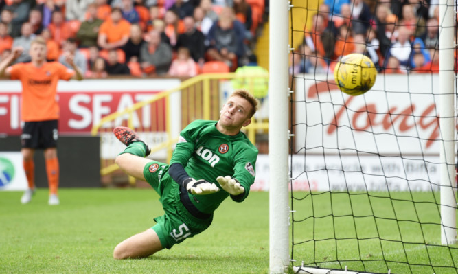 Dundee United keeper Luis Zwick looks on as the ball lands in his net.
