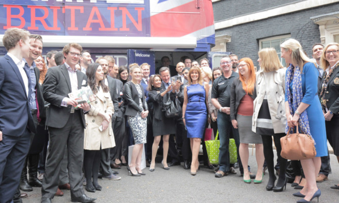 Scottish television presenter and entrepreneur Carol Smillie, blue dress, with Prime Minister David Cameron, centre, at the Downing Street launch of the StartUp Britain tour.