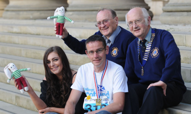 From left: Hannah Clark, fundraising and events assistant for the ARCHIE Foundation, club members David Kydd and Dick Lawson and club president Tom McDade.