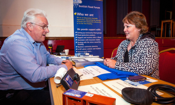 Operations Director with Scottish Flood Forum Paul Hendy chats with a woman in Alyth.