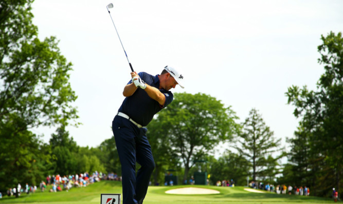 Graeme McDowell hits off the 12th tee.