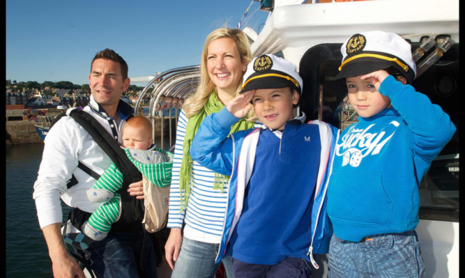 The Wharton family, dad Tsen with baby Harris, mum Emma, Laird, 7, and Radleigh, 5, on the new Forth ferry service.