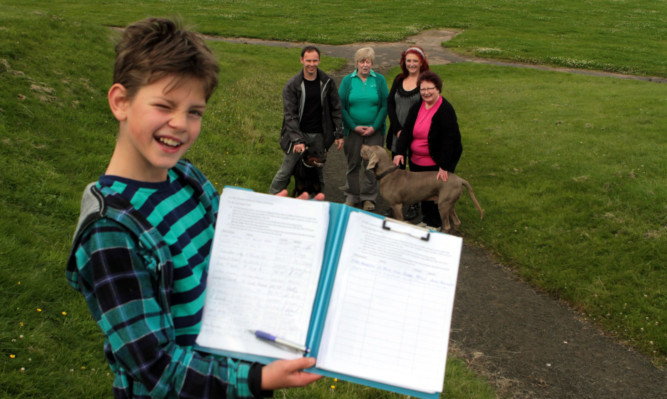 Eleven-year-old Alex Cragg with the petition and campaigners Graham Low, Jean Moir, Lynn Watson and Christine Mollison.