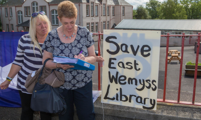 Freda Bernard signs the petition with protester Agnes Brown.